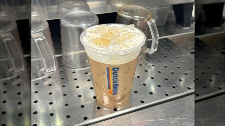 A Flap kack latte on a prep surface with soft foam and sugar
