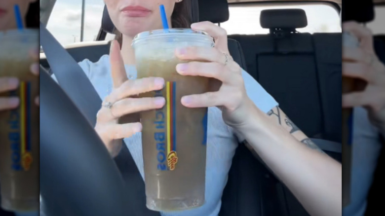 A person holding a Dutch Bros Red, White & Blue Rebel