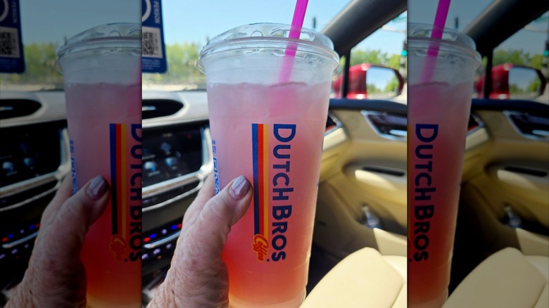 A person holding a passion water drink from Dutch Bros