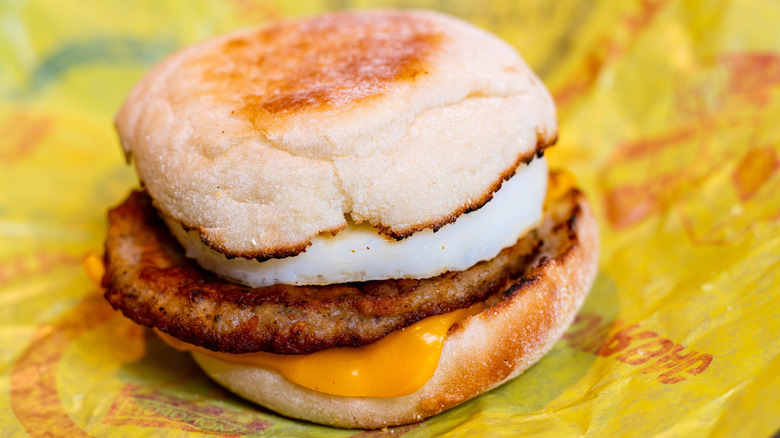A Sausage McMuffin sits on its wrapper