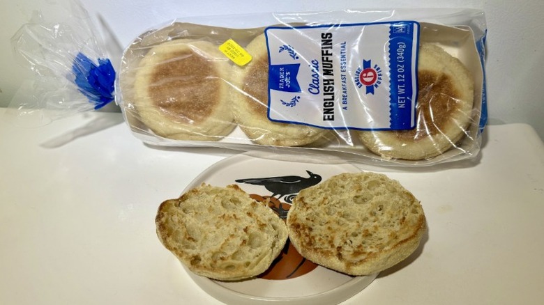 A package of Trader Joe's White English Muffins leaning on a plate with a toasted muffin on it