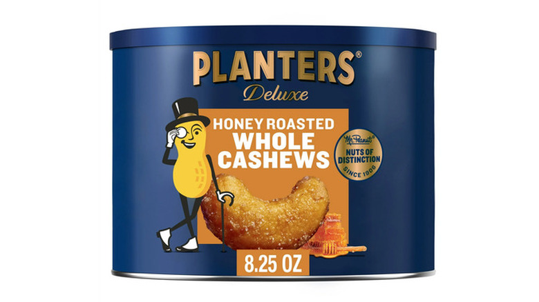 A can of Planters Deluxe Honey Roasted Whole Cashews on a white background