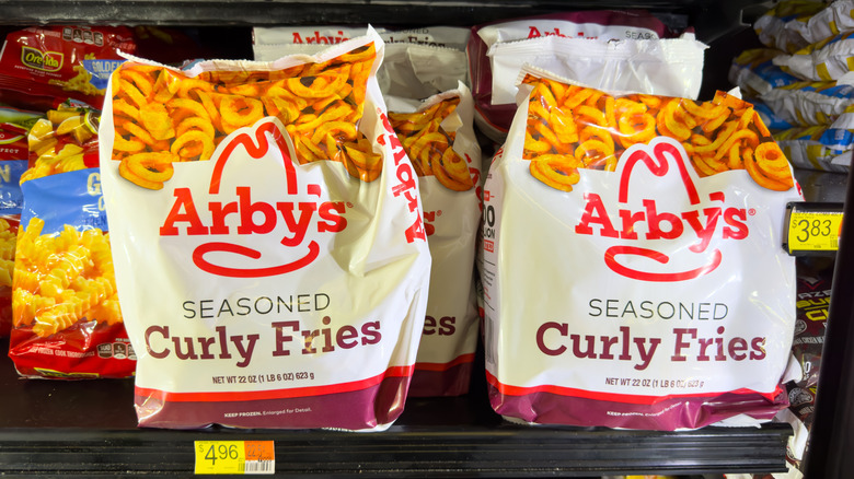 Arby's seasoned curly fries bags in a grocery store frozen goods case