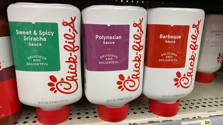 three bottles of Chick-fil-A dipping sauces on supermarket shelf