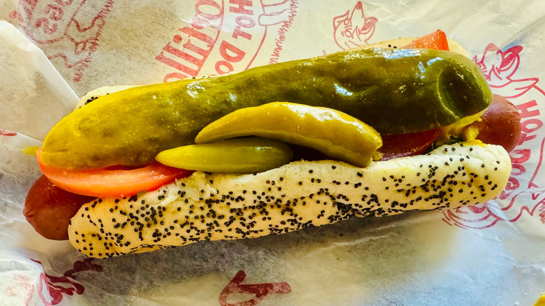 Portillo's hot dog with a pickle spear and peppers