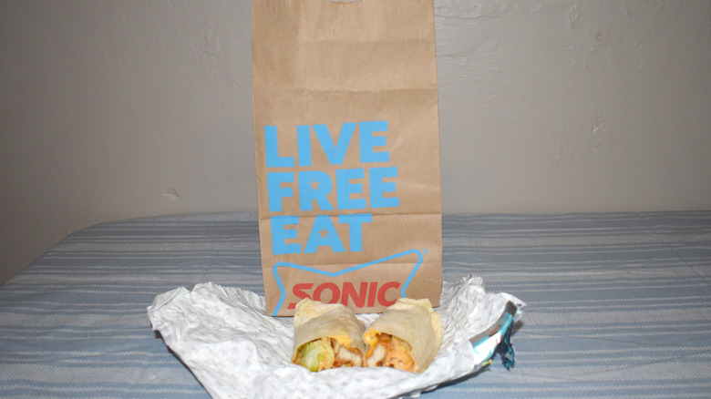 Honey Chipotle Crispy Tender Wrap in front of Sonic to-go bag