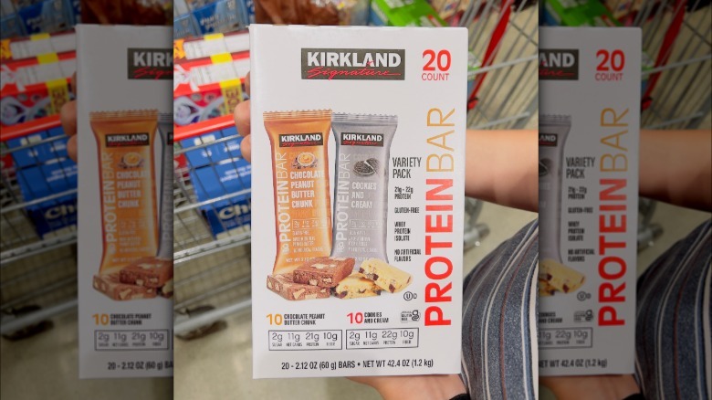 A box of Kirkland Signature protein bars in two flavors: cookies and cream and chocolate peanut butter chunk