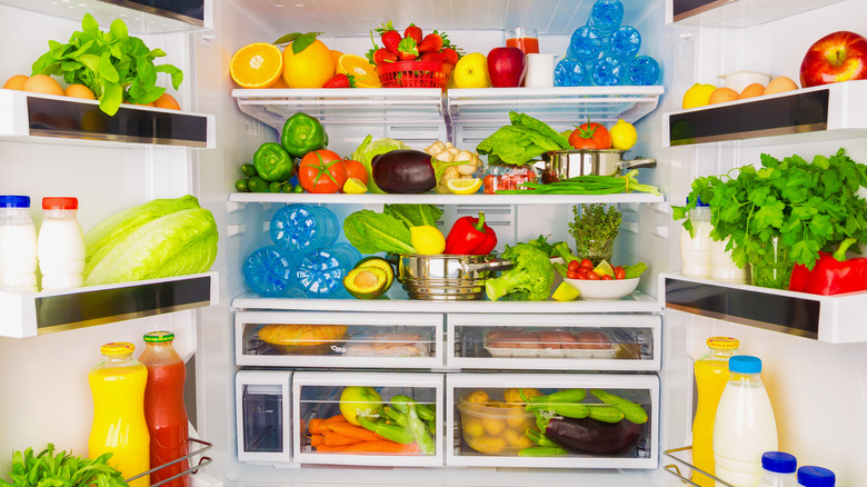 Open fridge full of fresh food