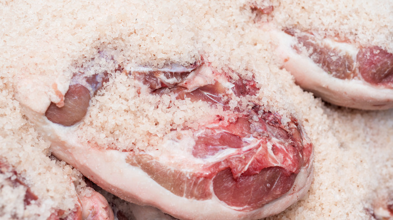 Iberico ham being cured in salt
