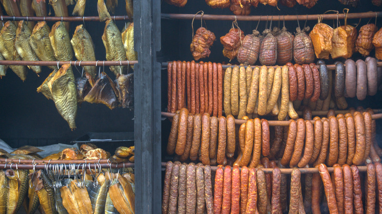 Smoked meats and fish hanging in a market