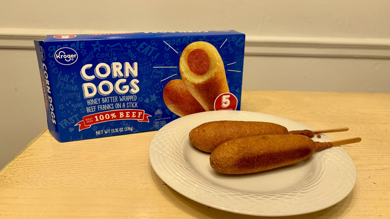 A plate of prepared Kroger Corn Dogs next to the box