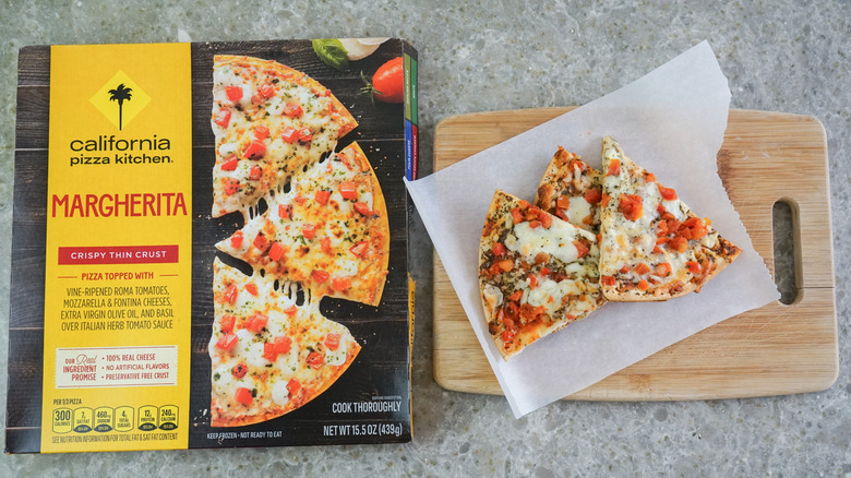 California Pizza Kitchen Margherita Thin Crust with Tomato-Basil Sauce next to slices on cutting board