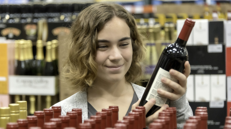 A happy customer perusing wines at Wegmans