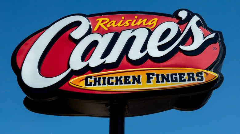 Shot of the Raising Cane's sign with blue sky in the background