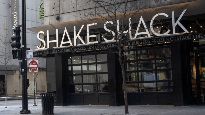 Exterior shot of a Shake Shack restaurant on a quiet street corner