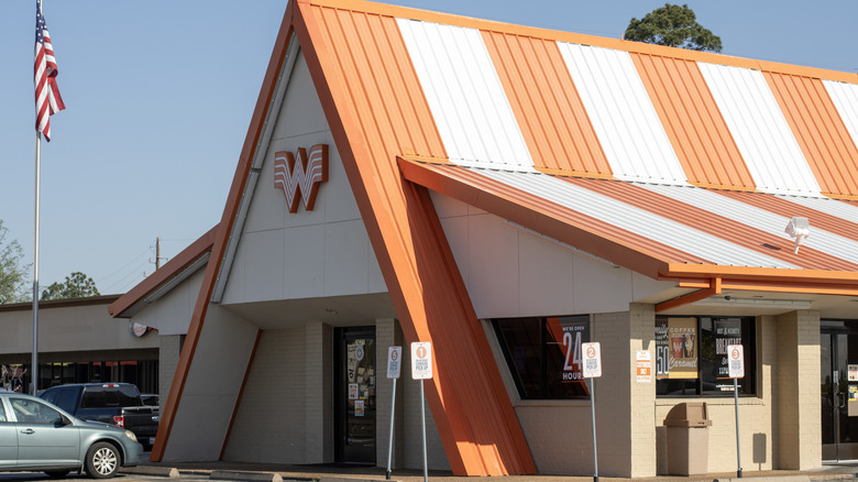 Outside shot of a Whataburger restaurant with a white and orange roof