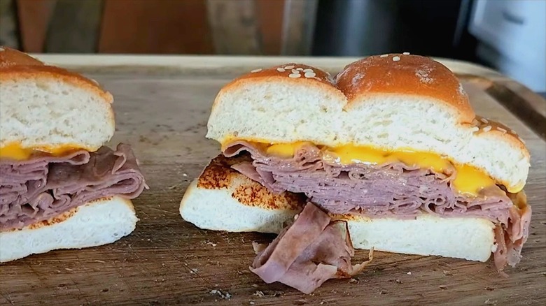 Arby's Melt sandwich cut in half with roast beef and cheddar cheese