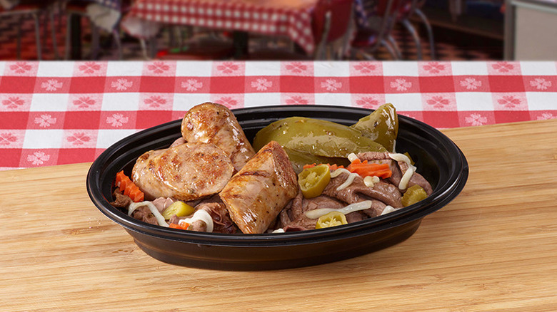 Portillo's beef bowl with Italian sausage, peppers, and mozzarella on wooden table