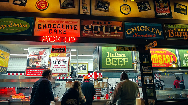 Counter at Portillo's Restaurant in Chicago, IL with neon signs and customers