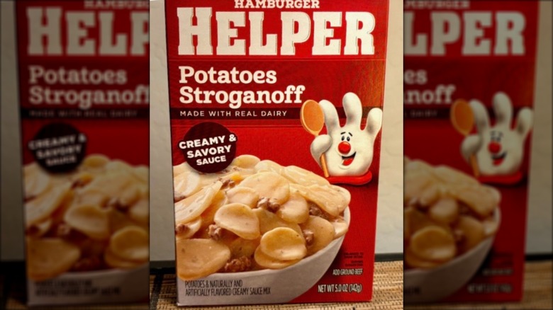 Box of Hamburger Helper Potatoes Stroganoff against beige wall