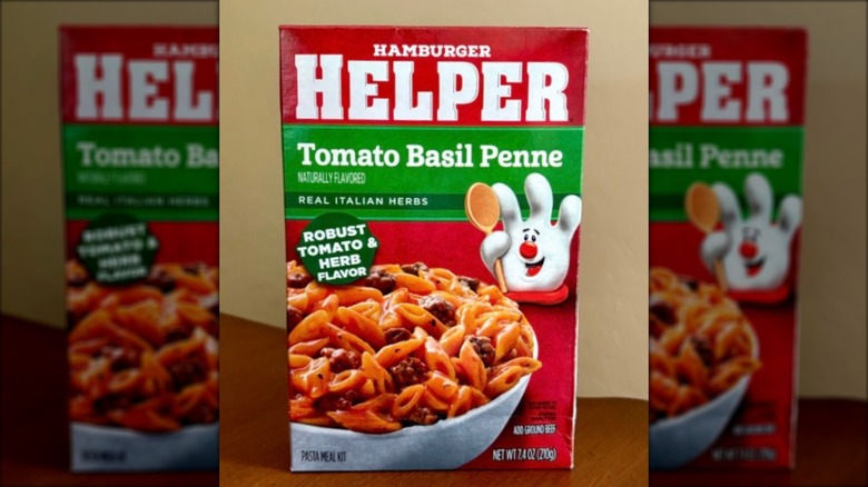Box of Hamburger Helper Tomato Basil Penne on brown, wooden table