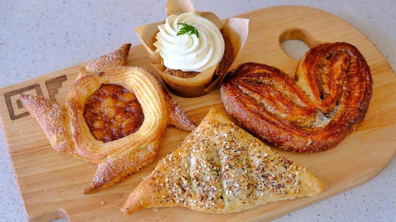 Four pastries from Gusto Bread on a wooden cutting board
