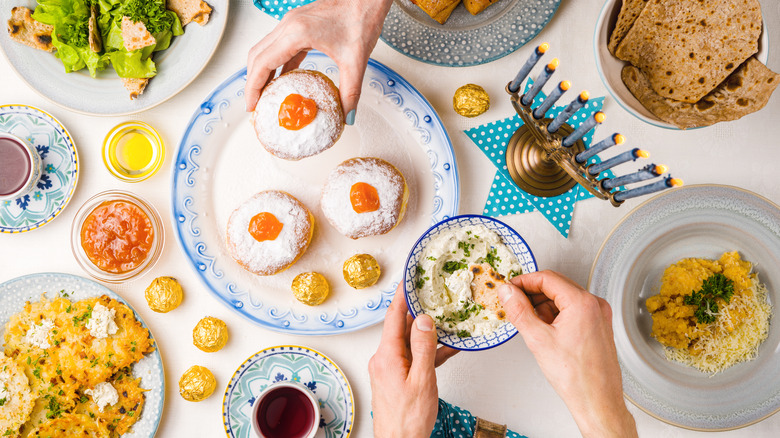 Platter of latkes, challah, and jelly doughnuts for Hanukkah
