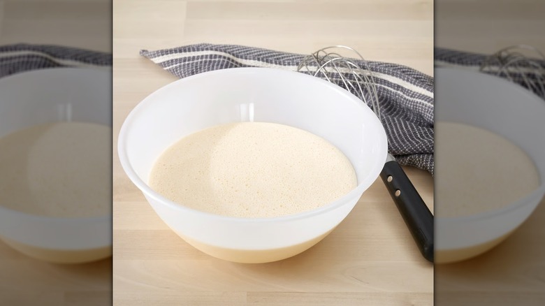 FIKADAGS mixing bowl with batter inside next to a dishcloth and whisk