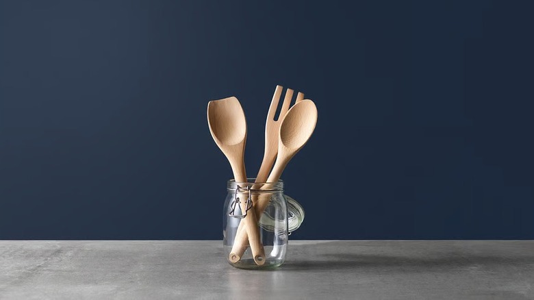 RÖRT spoons and fork in a glass jar with a navy blue background