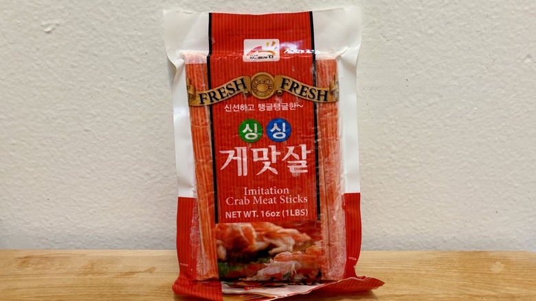 A package of Fresh Fresh Imitation Crab Meat Sticks against a white wall