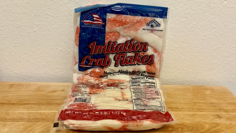 A package of Great American Seafood Imitation Crab Flakes against a white wall
