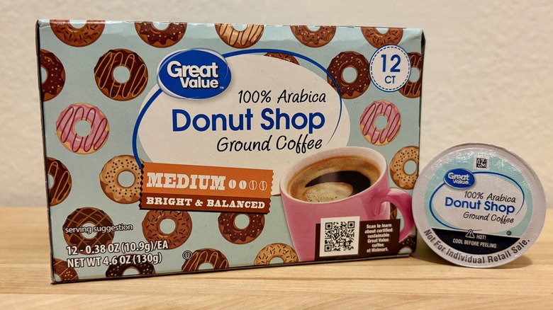 A box of Great Value Donut Shop K-Cups, next to a single coffee pod