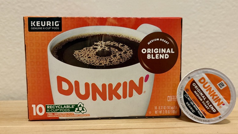 A box of Dunkin' Original Blend K-Cups, next to a single coffee pod