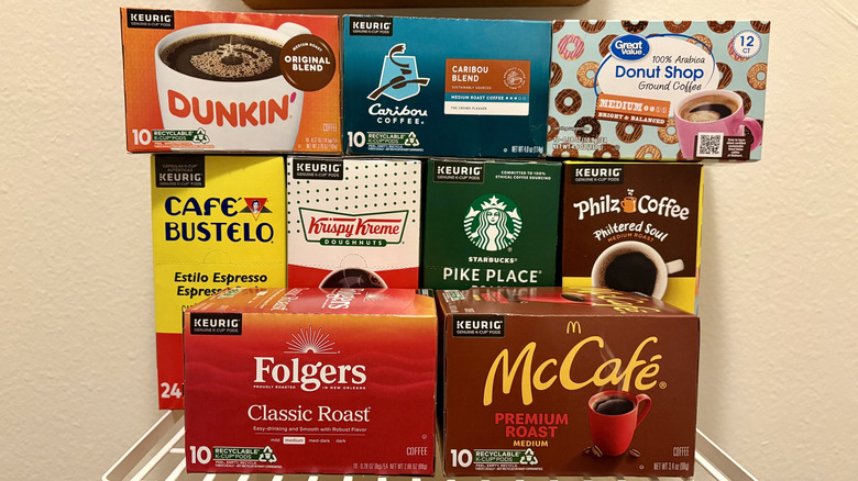 Boxes of different brands of Keurig coffee pods stacked on top of each other