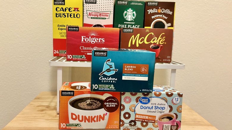 Boxes of different brands of Keurig coffee pods stacked on top of each other