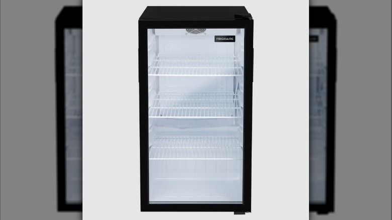 The Frigidaire Commercial Glass Door Display Fridge with a black exterior and fully glass fridge door showing a white interior.