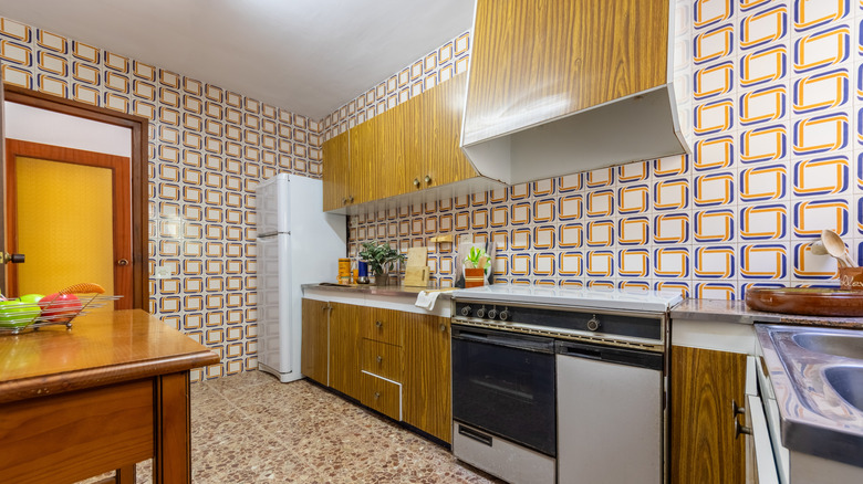 A kitchen with outdated tiling