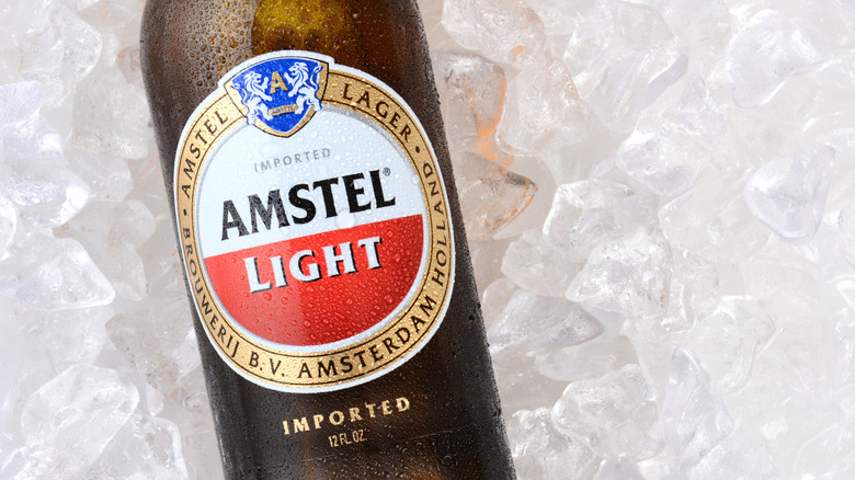 Close-up of bottle of Amstel Light on a bed of ice