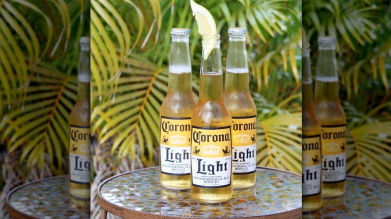 Three Corona Light bottles on outdoor table