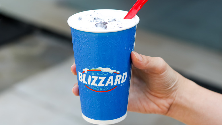 A person holding a Blizzard from Dairy Queen