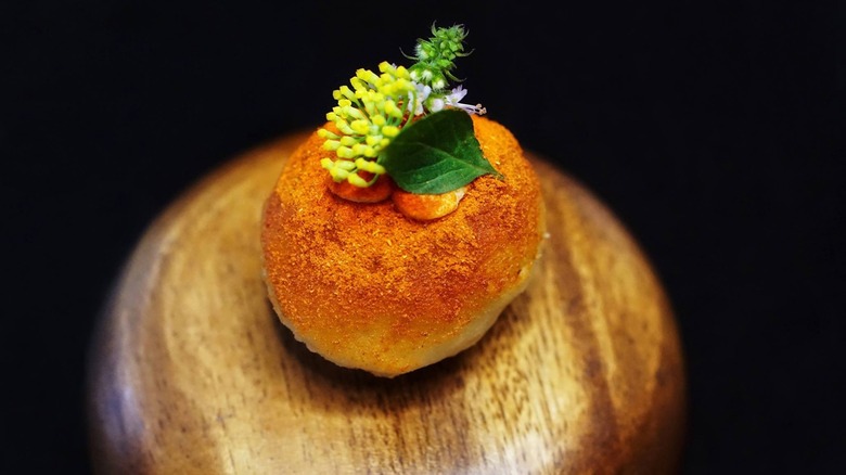 alinea dish on black background