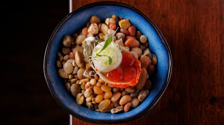 Oyster marinated in tomato dashi mignonette in a blue bowl