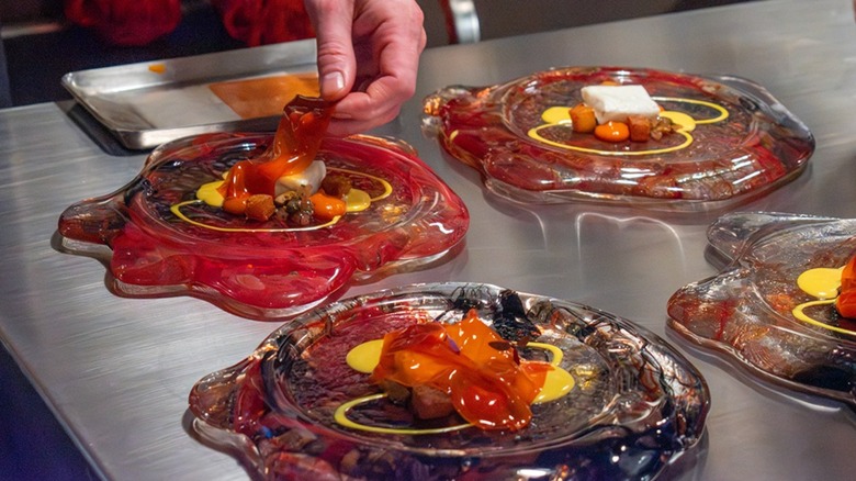 Chef plating elaborate, futuristic looking entrées