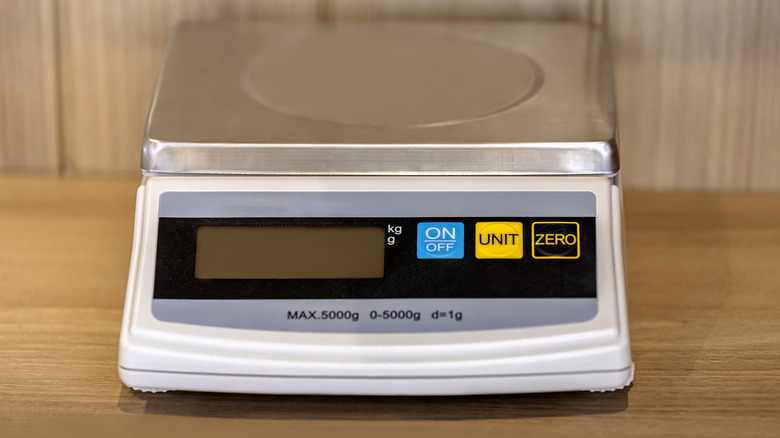 Digital food scale on wooden table