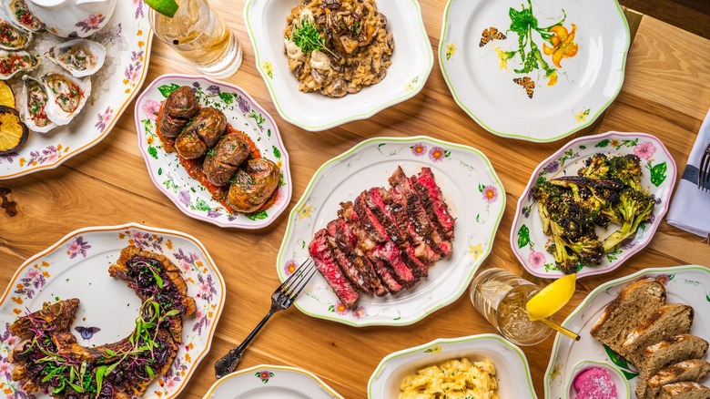 A variety of plates from Supperland spread across a wooden tabletop