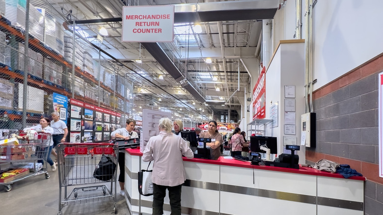 Woman standing at the "Merchandise return counter" at Costco