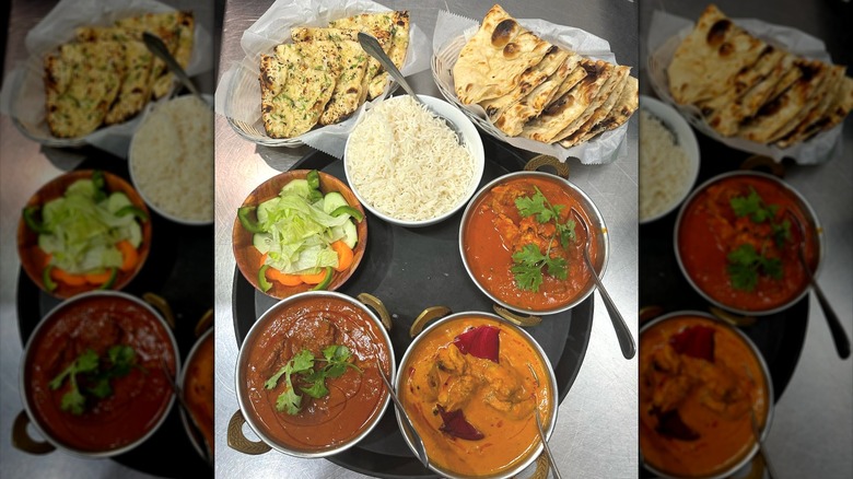 Tray of Indian curries with bread