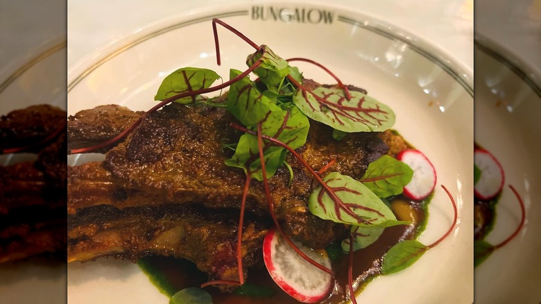 Roasted meat dish on ceramic plate