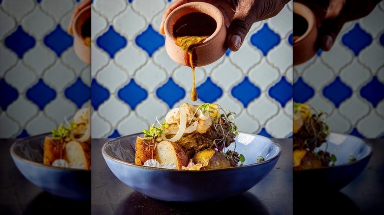 Indian Portuguese chicken dish with tile walls