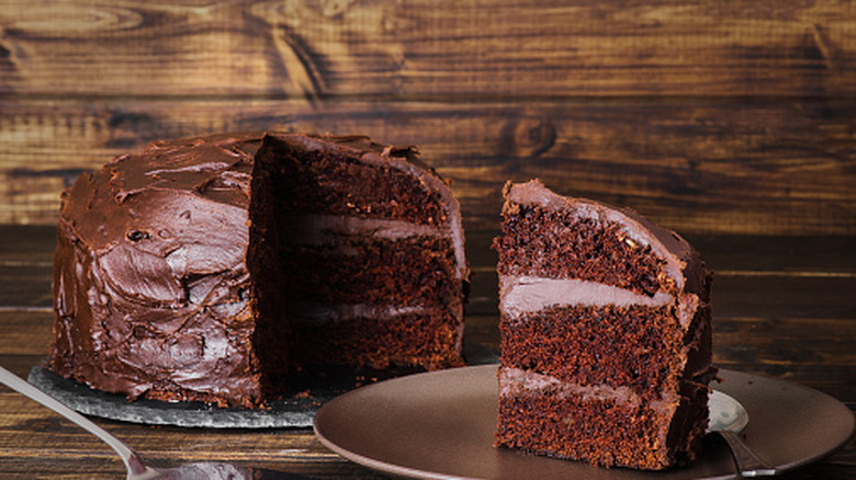 Chocolate devil's food cake on dark wooden background